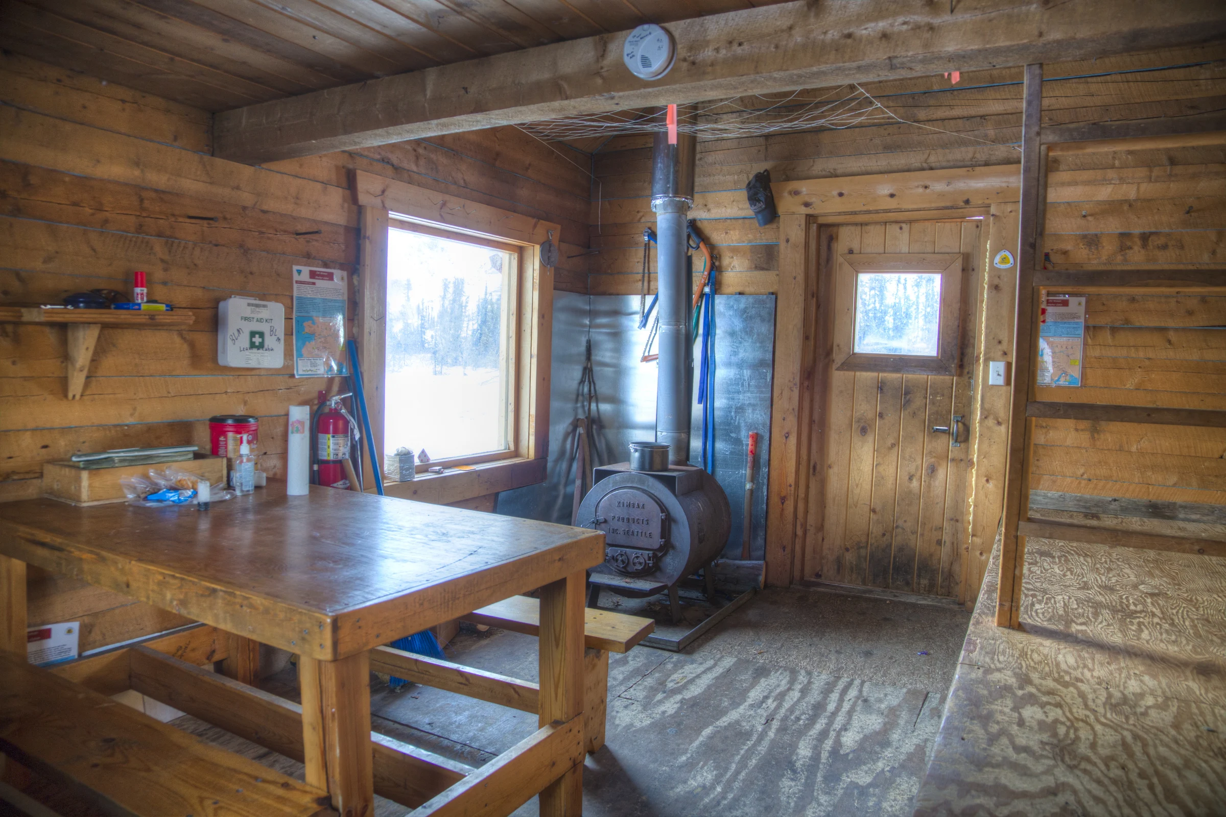 The wood-stove and shared interior of Old Woman Cabin on the Iditarod trail
